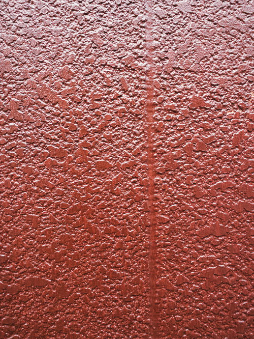 茶色にペイントされたモルタル壁のテクスチャ