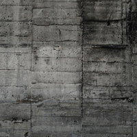 型枠の跡が規則的に残るグレーのコンクリート壁の写真