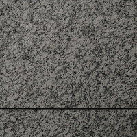 グレー系のまだら模様が入った石材タイルのテクスチャーの写真