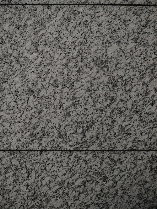 グレー系のまだら模様が入った石材タイルのテクスチャー