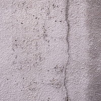 ひび割れを補修したモルタル壁のテクスチャーの写真