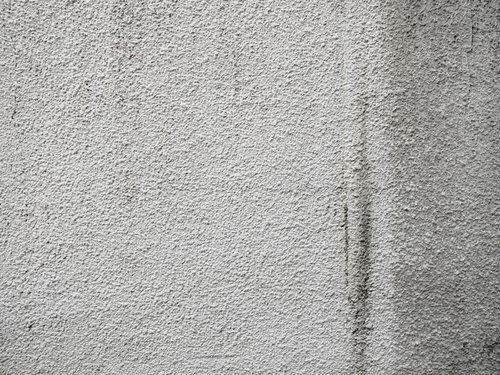 薄汚れたモルタル壁のテクスチャ 風化した外壁