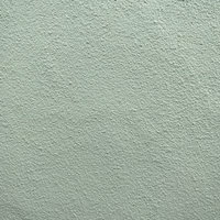 淡いグリーンに塗装されたモルタル壁のテクスチャの写真