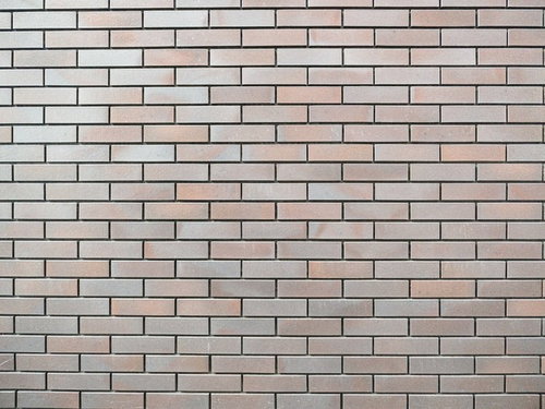 薄茶色と白色のレンガ調タイル壁のテクスチャ