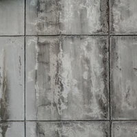 ひび割れと染みが残るグレーのタイル壁テクスチャーの写真