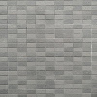 グレー系の外壁タイルが規則正しく並ぶテクスチャーの写真