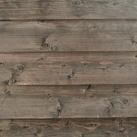 節跡が目立つ縦張り板壁のテクスチャーの写真