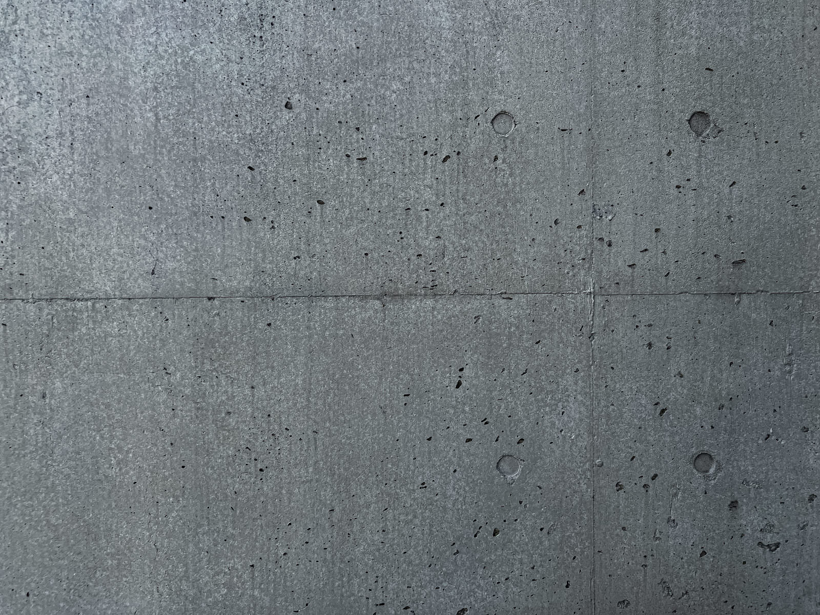 グレーのコンクリート壁の質感が写った無機質なテクスチャー