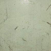 経年劣化による汚れが広がる緑色の外壁の劣化の写真
