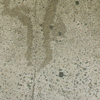 コンクリート表面に残る縦方向のヒビとシミのテクスチャの写真