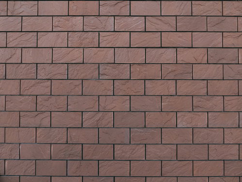 赤茶色のレンガ自体に凹凸のある壁のテクスチャ