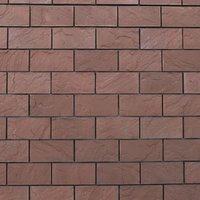 茶色いレンガと白い目地のメリハリある外壁の写真