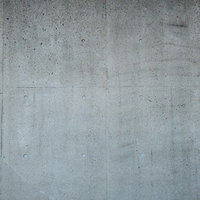 汚れが付着した打ちっぱなしのコンクリート壁の写真