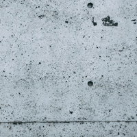 ブツブツなむき出しのコンクリート壁の表面の写真