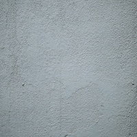 ざらつく塗装したグレーの壁面のテクスチャーの写真