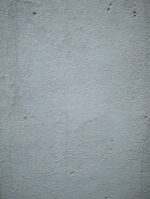 ざらつく塗装したグレーの壁面のテクスチャー