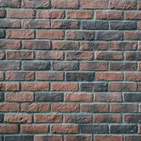 雨風を受けて角が丸くなったレンガ壁のテクスチャーの写真