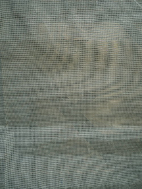 工事現場にかかっている緑色の防護ネットのテクスチャー