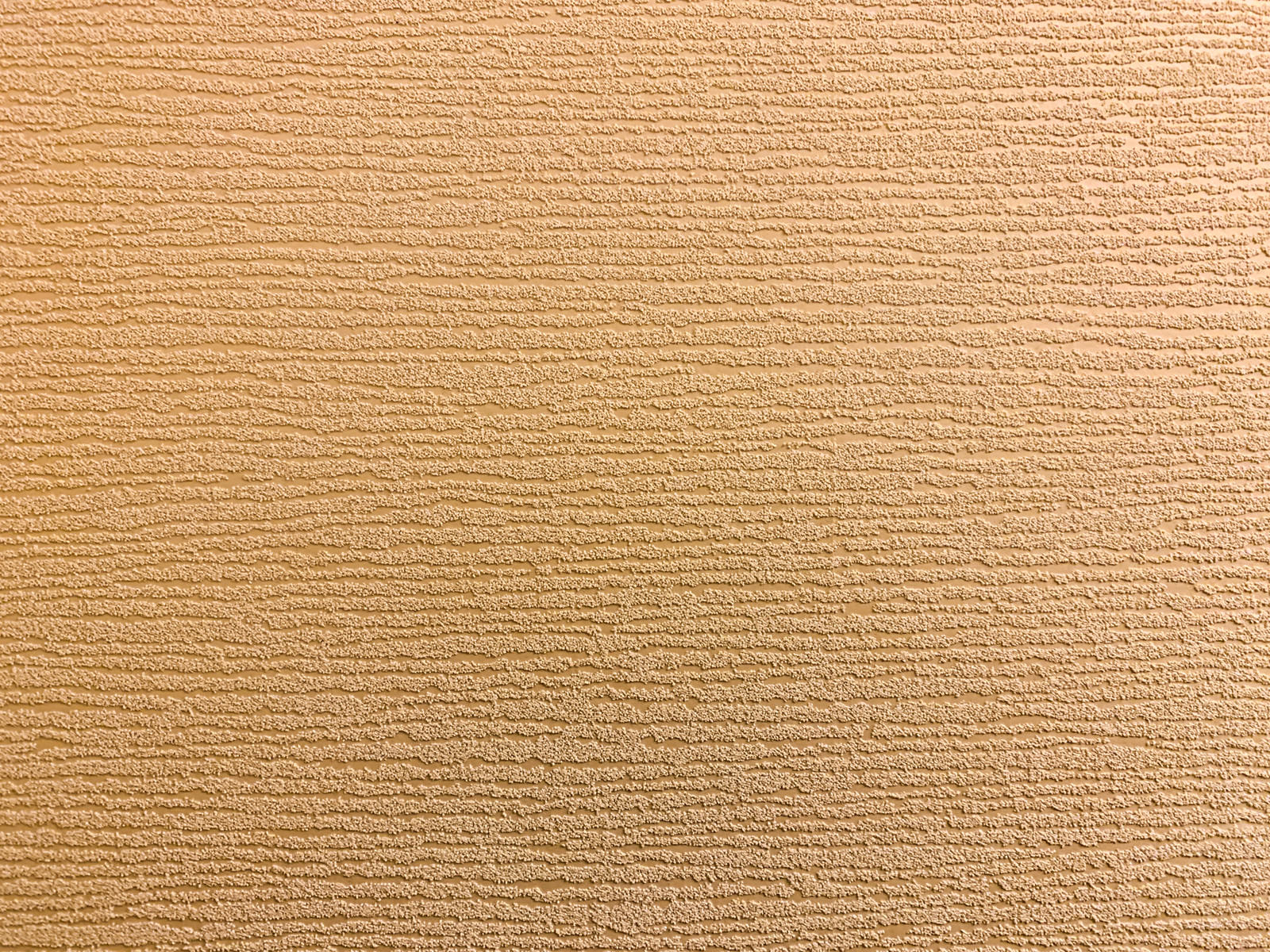 茶色でザラザラした質感の床材のテクスチャー