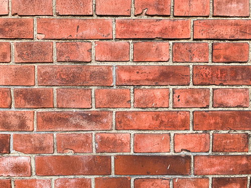 洗っても取れない黒ズミの赤レンガ壁のテクスチャー