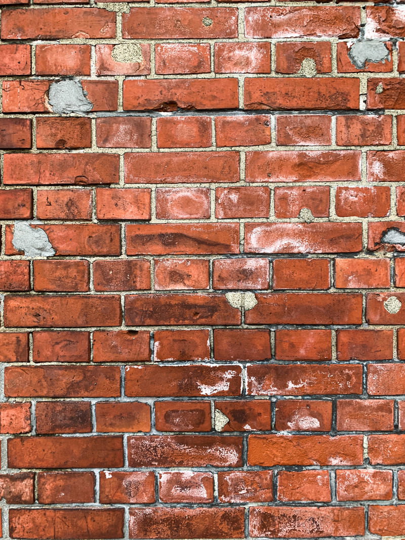 Weathered red brick wall surface
