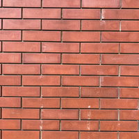 テープ跡の残る赤レンガのテクスチャーの写真