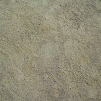 運動場の砂地に残る複数の足跡（テクスチャー）の写真