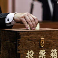 投票箱に清き一票を投じる市議会議員の民主主義実践の写真
