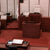 議長席と登壇席、質問席が一直線上に配置された議場の風景の写真