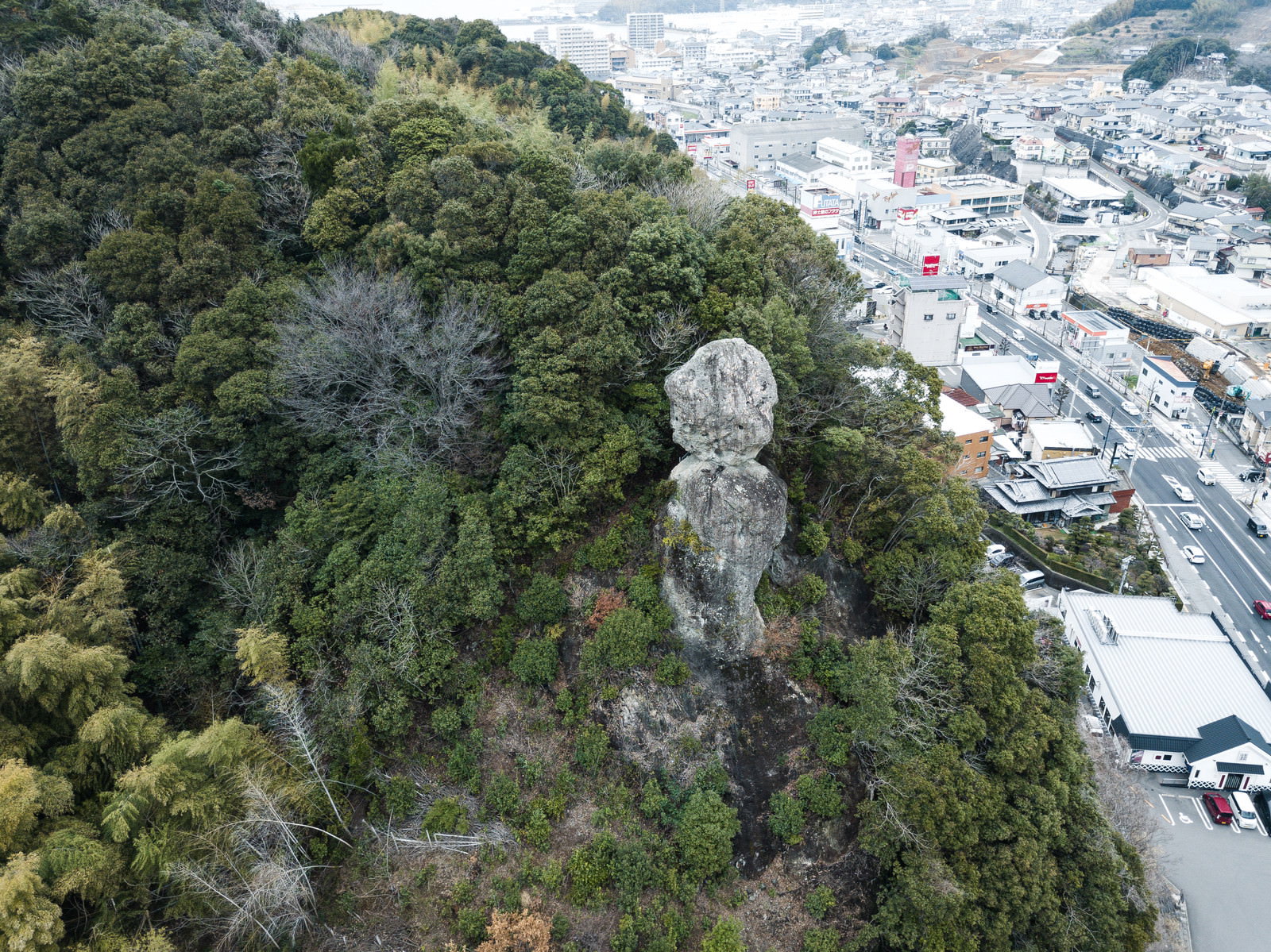 時津町の森に囲まれた鯖くさらかし岩と港町を空撮した風景