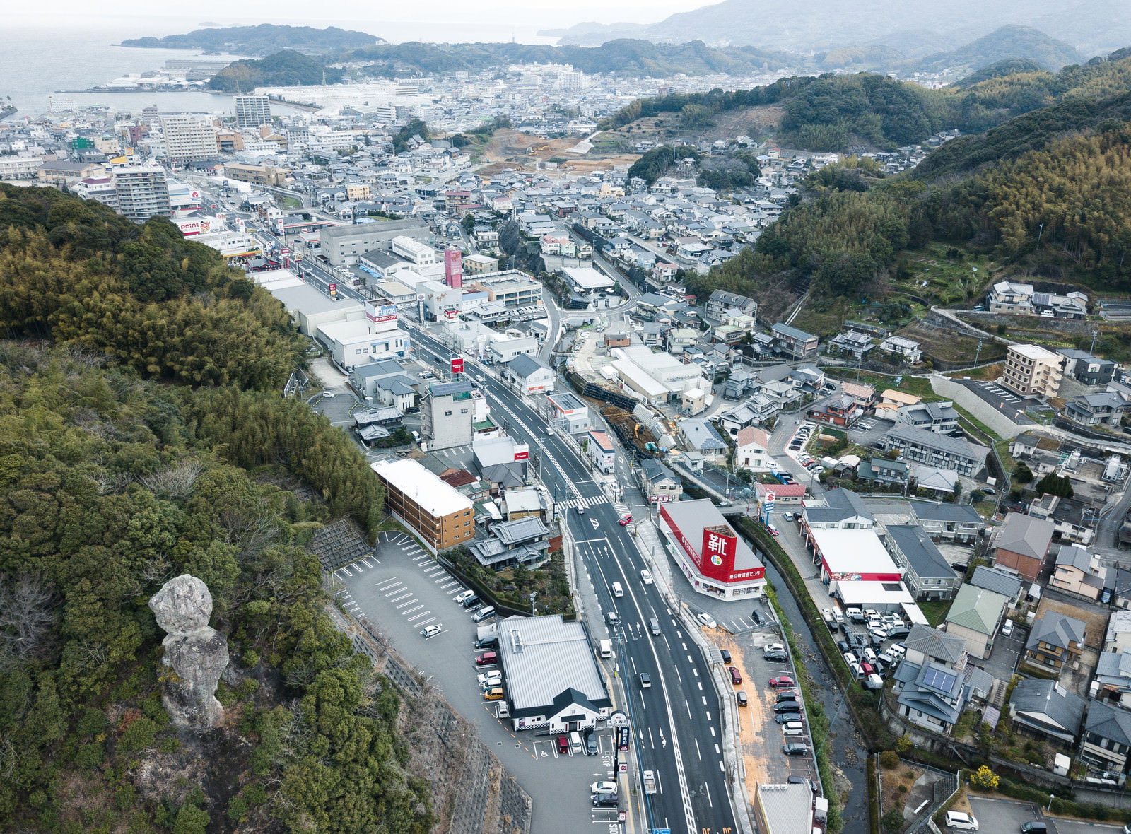 高台から見下ろす時津町の住宅街と港の風景、手前に鯖くさらかし岩