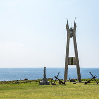 徳之島犬田布岬の戦艦大和慰霊塔と青い海原の写真