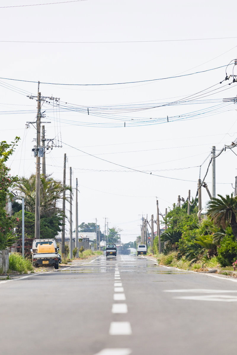 滑走路跡を利用した平和通りの直線道路と電柱が続く風景