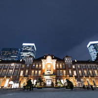 ライトアップされた東京駅丸の内口の夜景と高層ビル群の写真