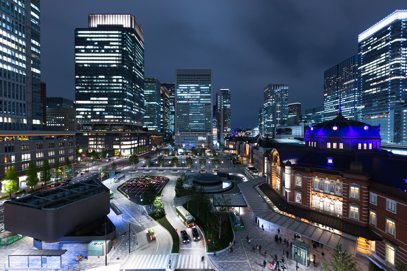 東京駅前の丸の内高層ビル群と駅舎が夜間にライトアップされた都市夜景