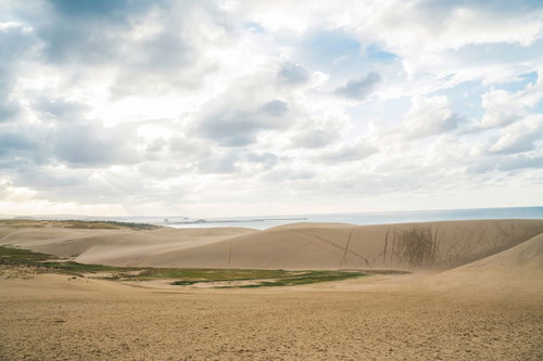 曇り空を覆う雲と鳥取砂丘の風景、砂地の起伏