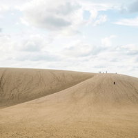 鳥取砂丘の広大な砂丘斜面を歩く観光客たちの写真