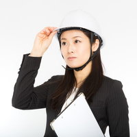 災害時の安全対策としてヘルメットを着用する女性社員の写真