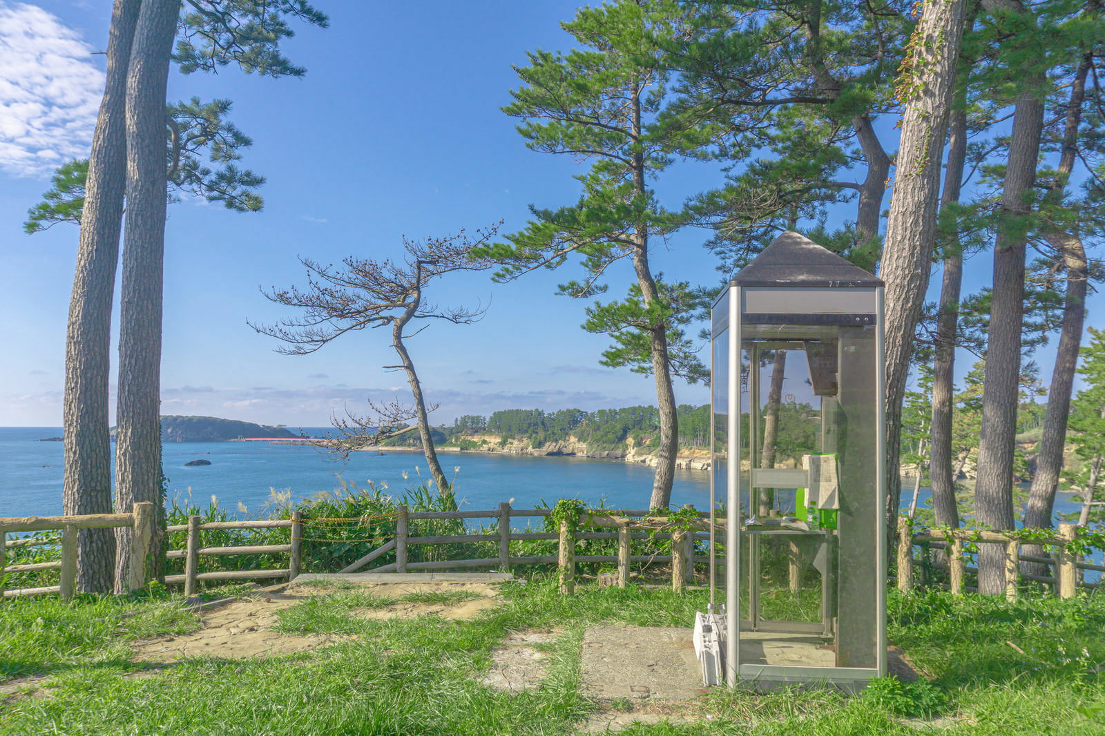東尋坊芝生広場の端にある公衆電話ボックスと遠くに見える雄島