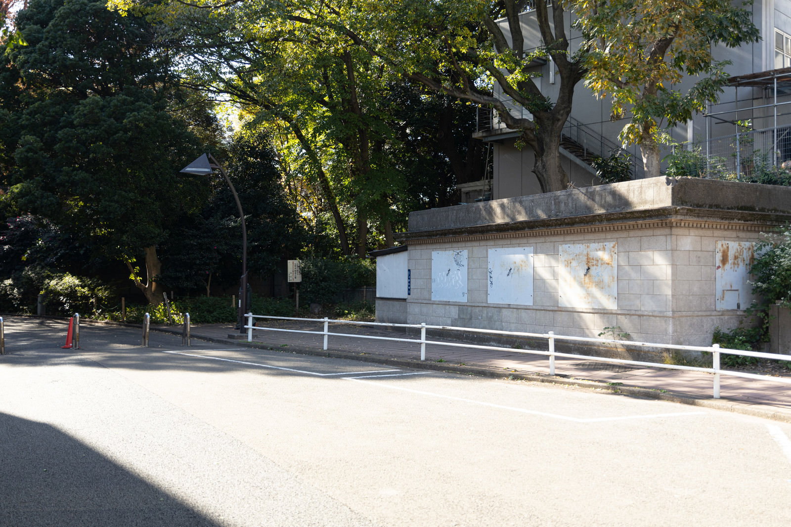 The white stairs and handrails of the former Ueno Zoological Garden Station, surrounded by green trees