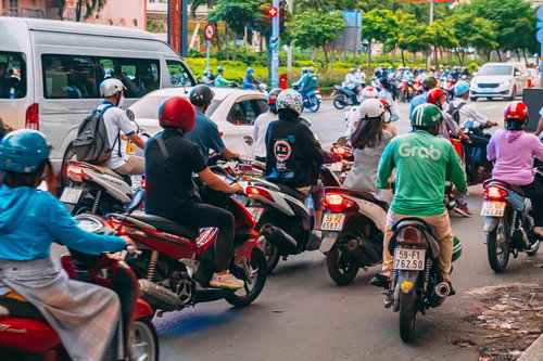 赤信号で大量に原チャが待っているホーチミンシティの車道