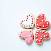 向き合う白とピンク、赤のハートのアイシングクッキーの写真