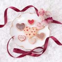 くるくる赤リボンとハート形のバレンタインクッキーの写真