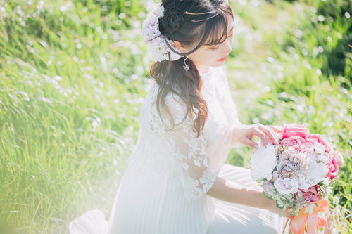 ウェディングドレスの花嫁がブーケの花を本数を数える