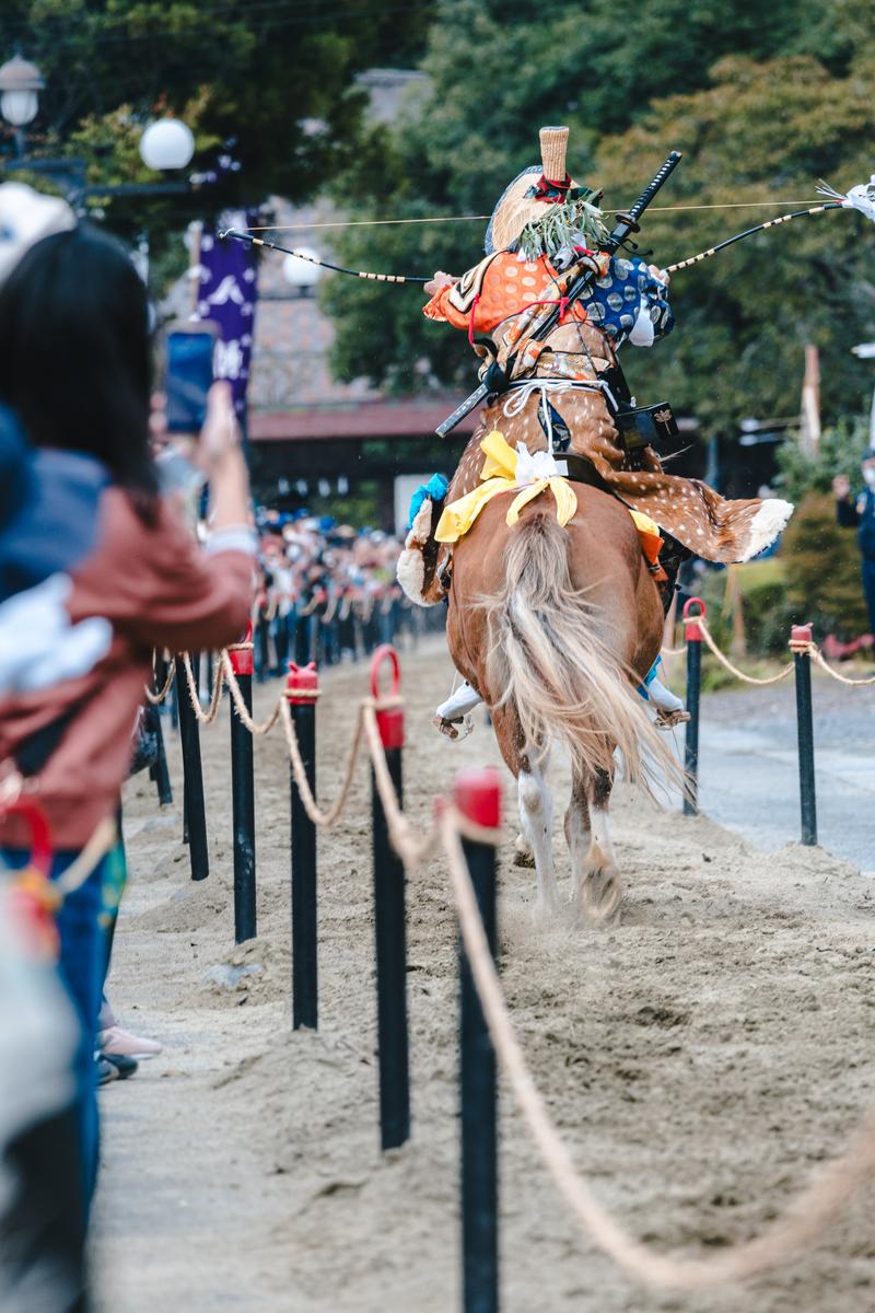 古殿八幡神社の流鏑馬で馬上から疾走する矢を背負った射手