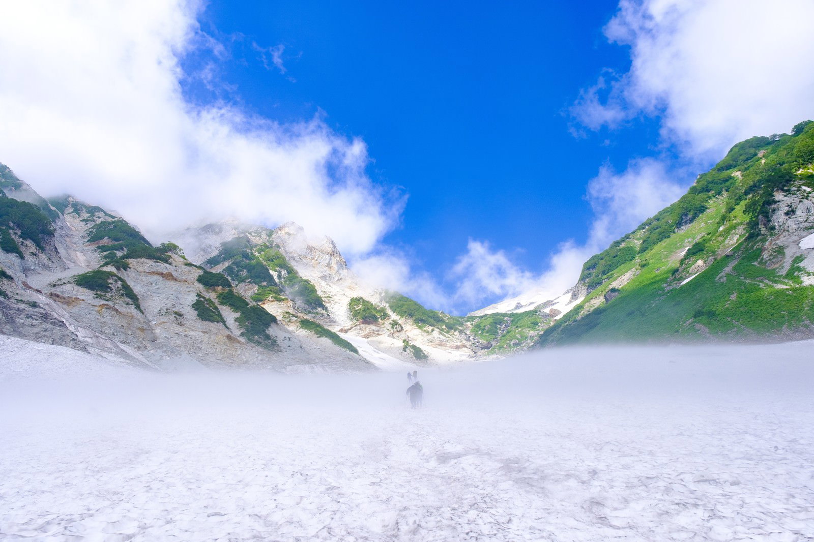 白馬大雪渓を登る登山者と青空が広がる白馬岳の雪渓風景