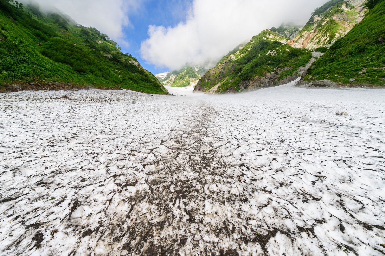 白馬大雪渓の雪渓が山間の谷に延びる光景