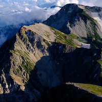白馬岳から望む杓子岳と白馬鑓ヶ岳の雲海と稜線の写真