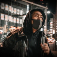 繁華街の夜間で走る黒いマスク姿の男性の逃走シーンの写真