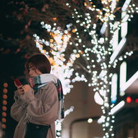 駅前のイルミネーション前で待ち合わせる彼女の写真